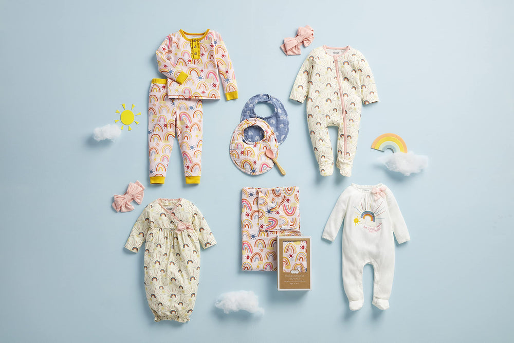 Mud Pie Rainbow Muslin Swaddle Blanket in use for a snug wrap on the go.