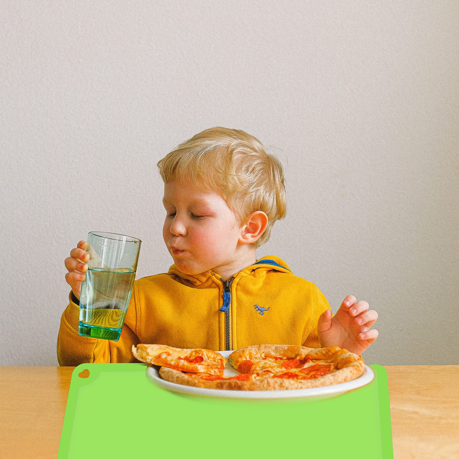 Mudocp silicone placemat green mat laid flat on table for family dinner.