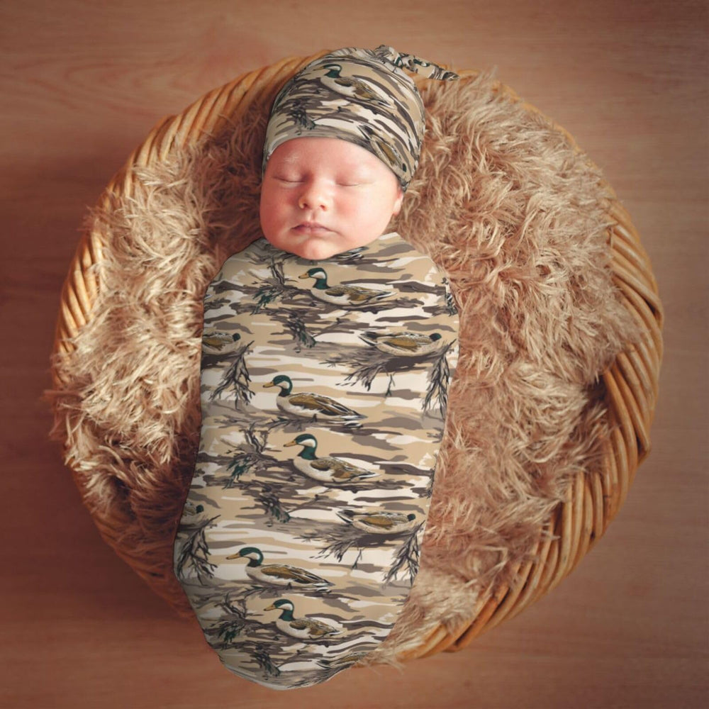Muishi duck camouflage swaddle used as a newborn photo prop.