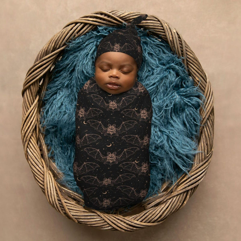 Muishi Night Bat Moon baby-in-swaddle scene shows cozy snug wrap