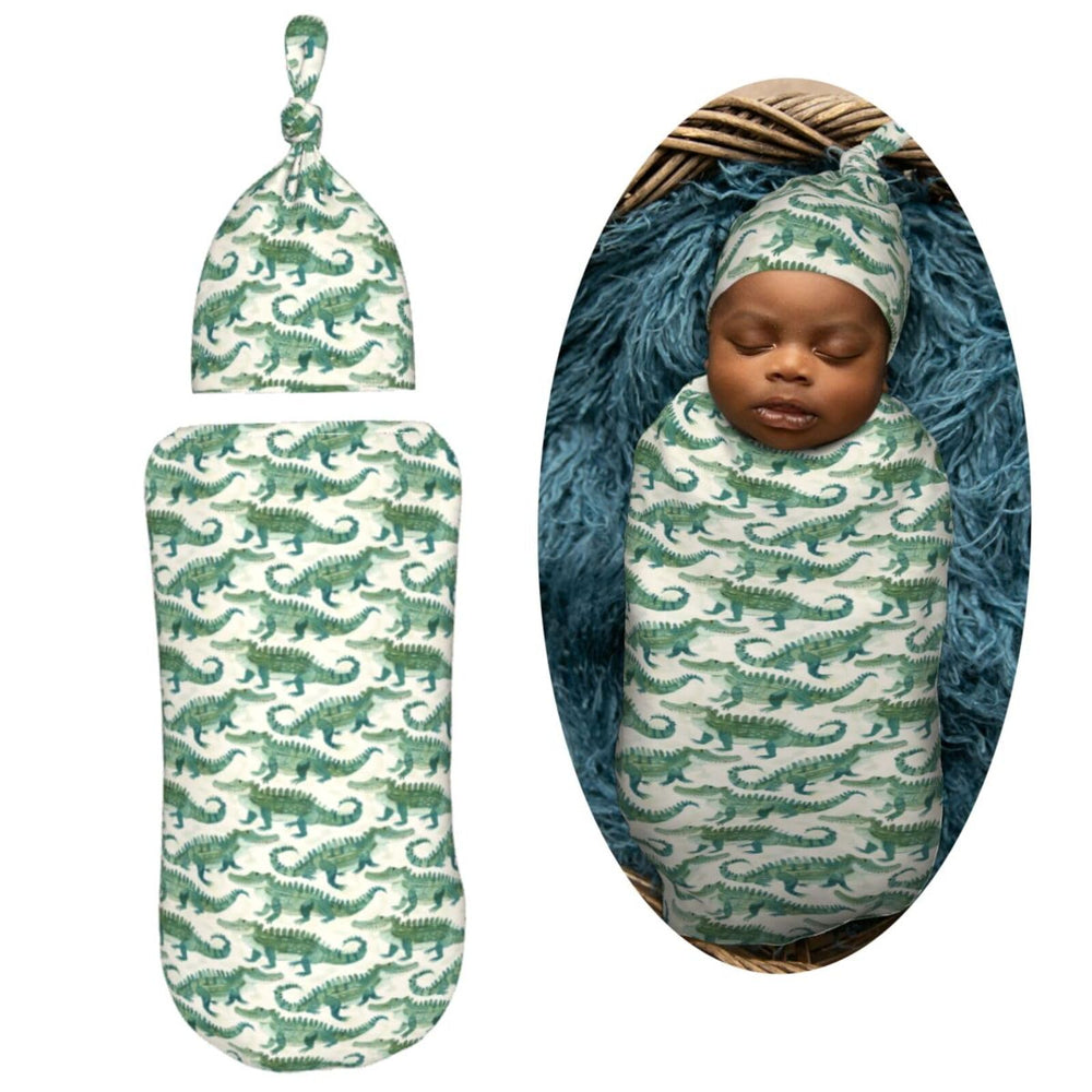 Muishi crocodiles swaddle wrapped for snug cocoon.
