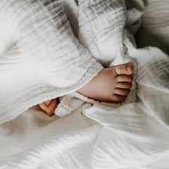 MUKIN white swaddle blanket suited for cozy newborn swaddling.