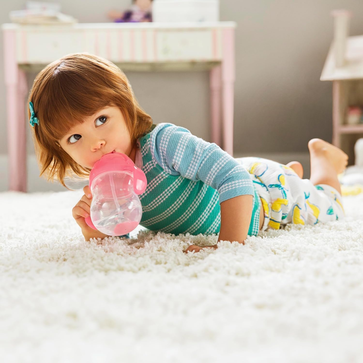 Munchkin any-angle straw cup enables sipping from any position.