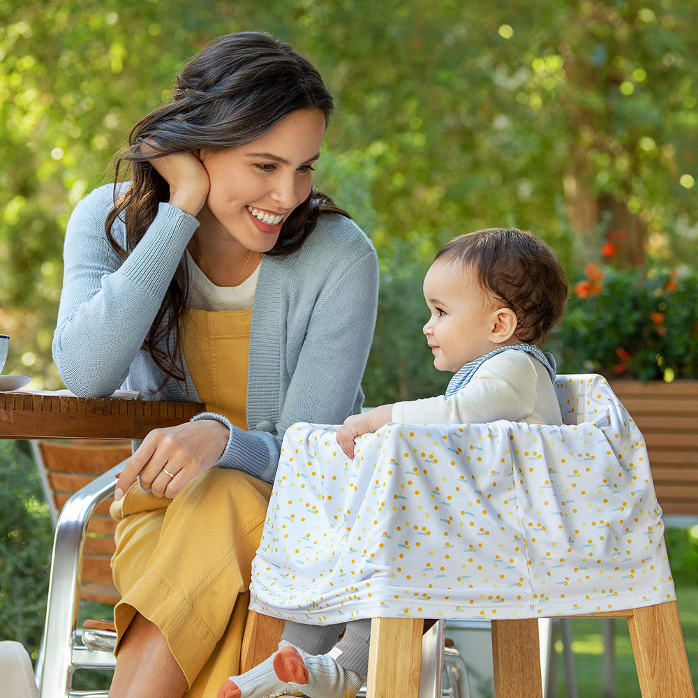 Shopping cart cover by Munchkin Milkmakers protects baby during errands.