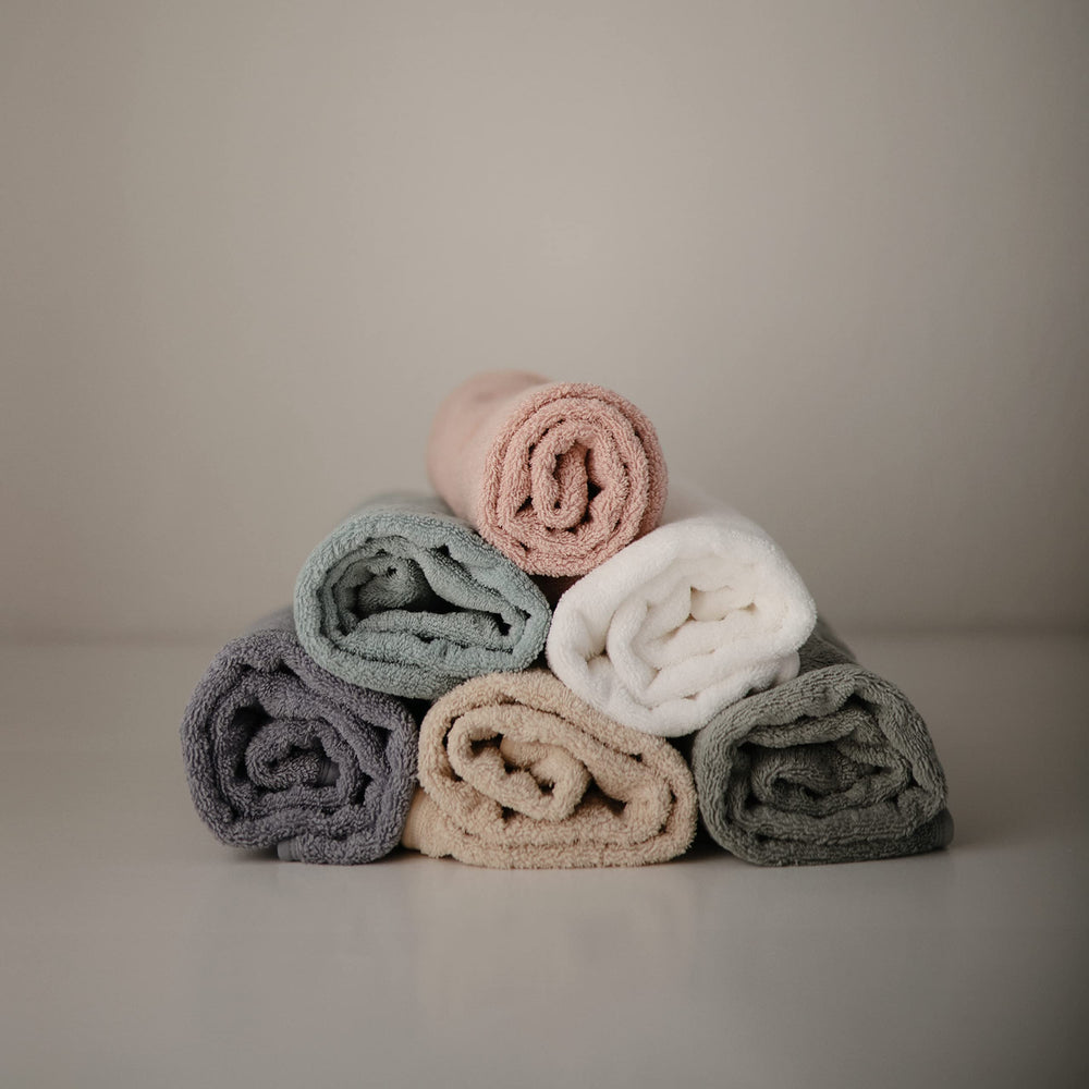 Mushie gray hooded towel on baby demonstrating warm drying moment