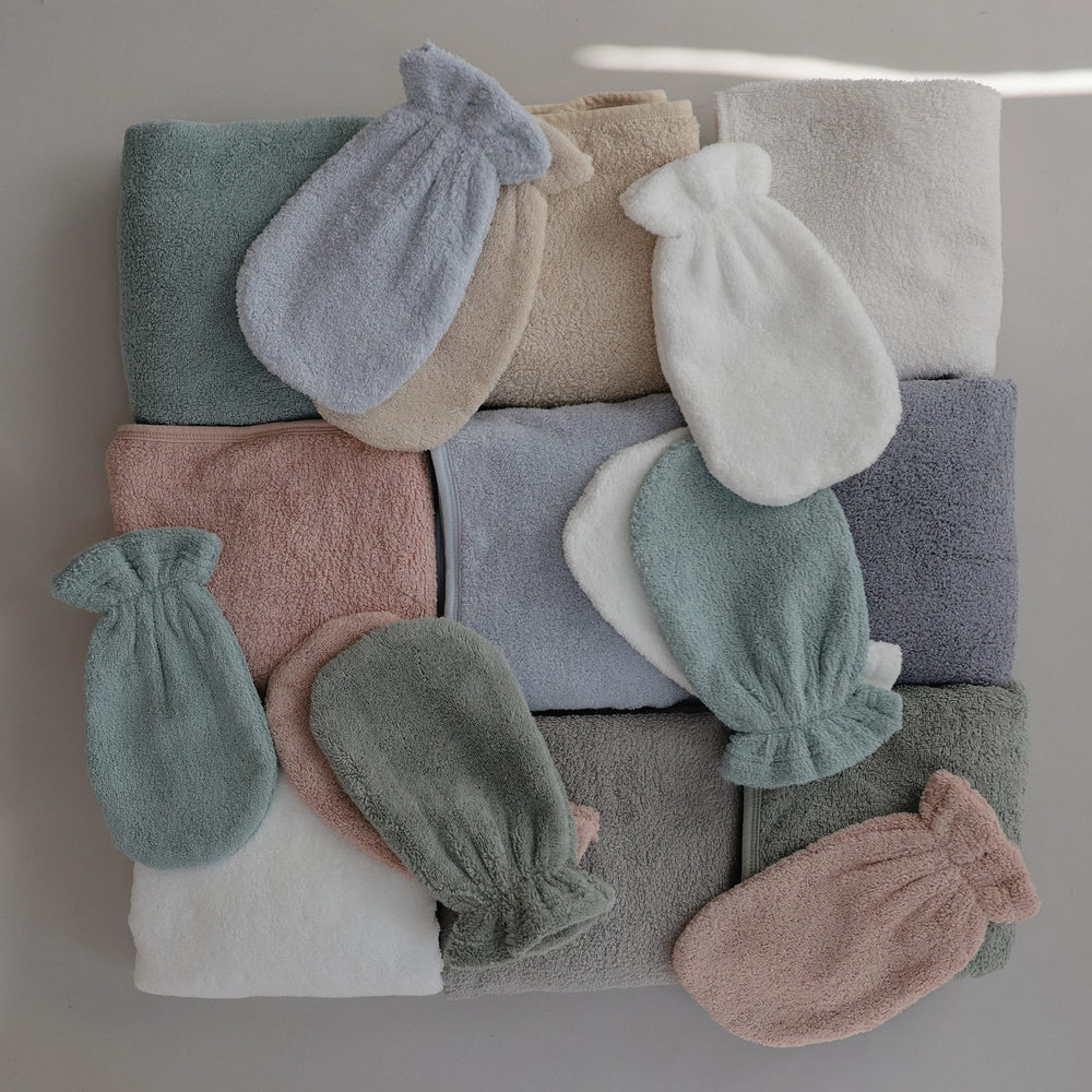 Mushie color-baby-blue towel shown ready for bath-time routines.