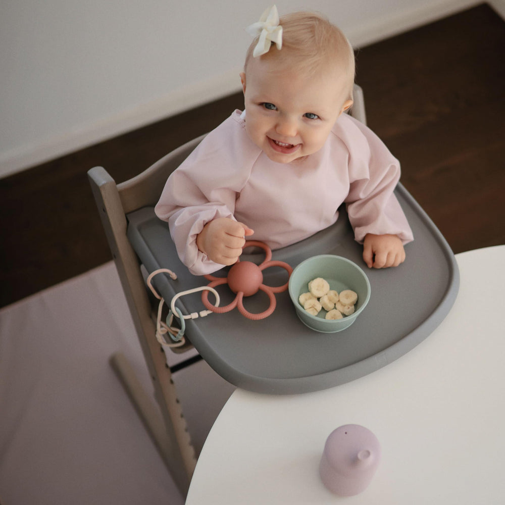 Mushie Baby Splat Mat machine washable for bigger messes.