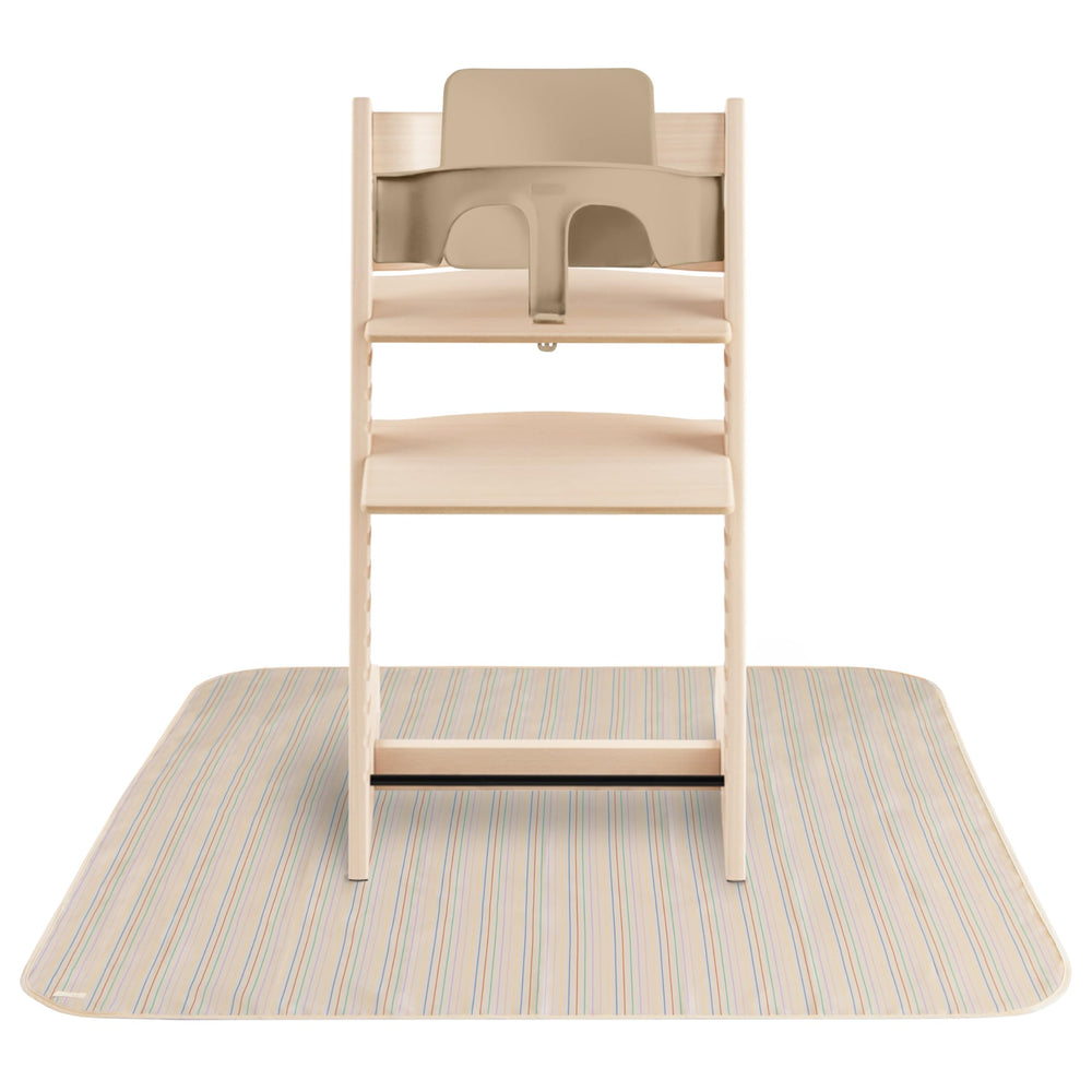Mushie Baby Splat Mat under high chair protects surfaces during meals