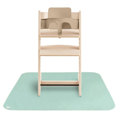 Mushie splat mat under high chair for clean mealtimes.