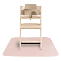 Mushie Baby Splat Mat under high chair protects floors during meals.