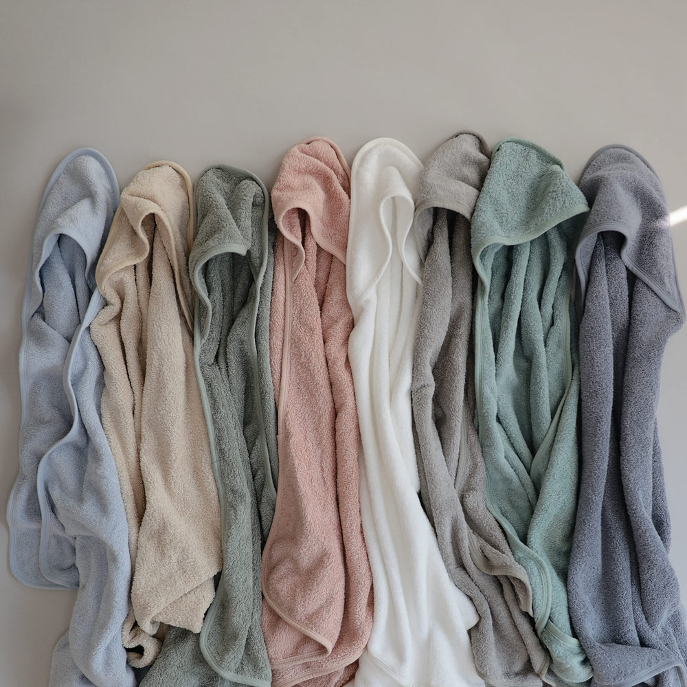 Mushie towel pictured in a cozy bathroom scene.