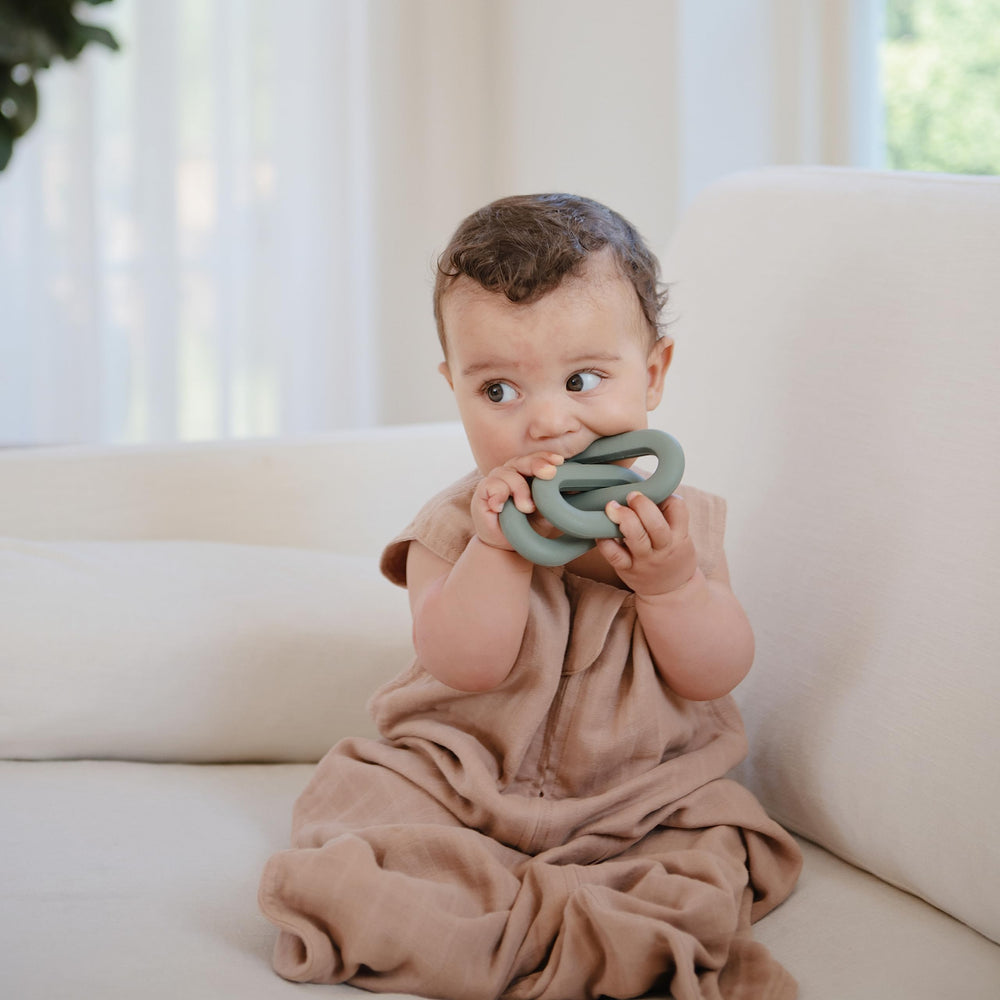Mushie wearable blanket sleeveless design allows tiny legs to move freely.