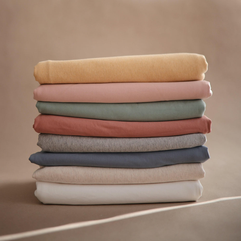 Breathable organic cotton texture of Mushie wrap in Roman Green.