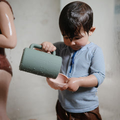 Mushie bath rinse cup in dried thyme color for calm bath moments.