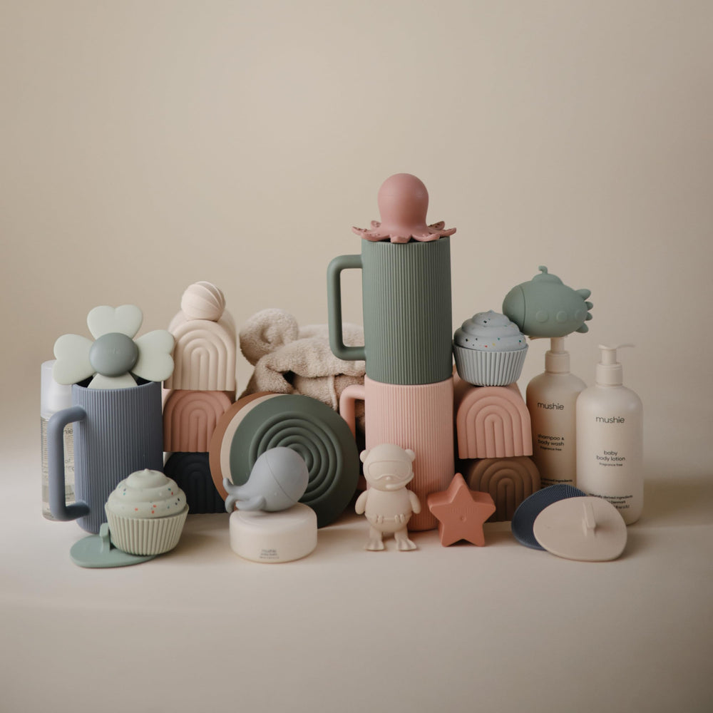 Mushie top rack dishwasher-safe bath rinse cup for easy care.