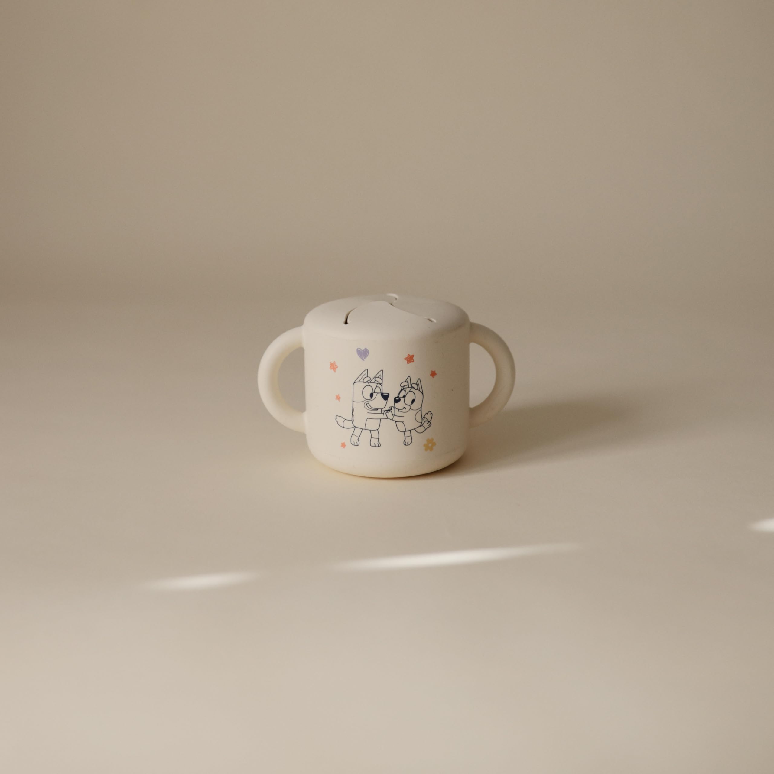 Mushie Bluey snack cup with two handles aids little hands during meals.