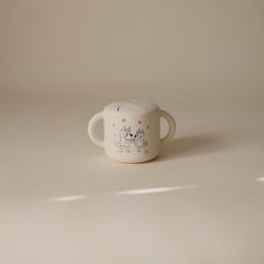 Mushie Bluey snack cup with two handles aids little hands during meals.