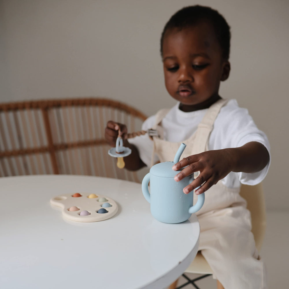 Mushie cup labeled BPA/BPS/PVC-free for safety.