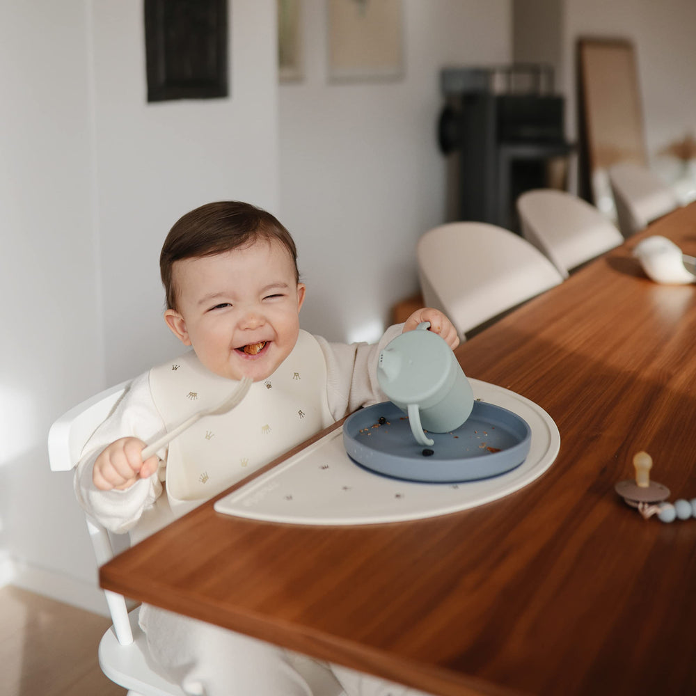 Mushie Classic Silicone Suction Plate stone with food illustrating easy cleaning.