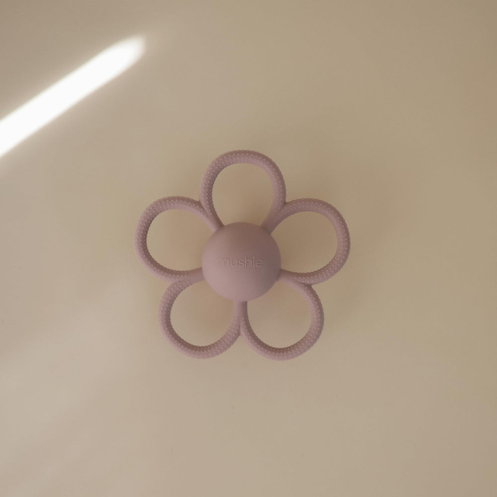 Close-up of Mushie Daisy rattle teether showing textured silicone surface.