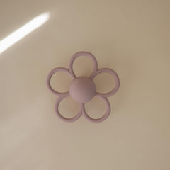 Close-up of Mushie Daisy rattle teether showing textured silicone surface.