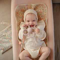 Mushie Daisy rattle teether handles designed for small hands grip.