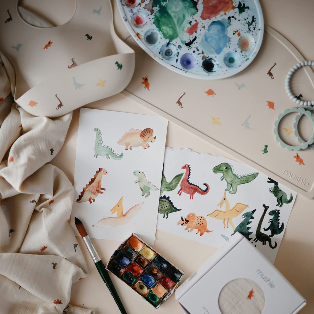 Mushie dinosaur bib designed in Sweden for timeless style.