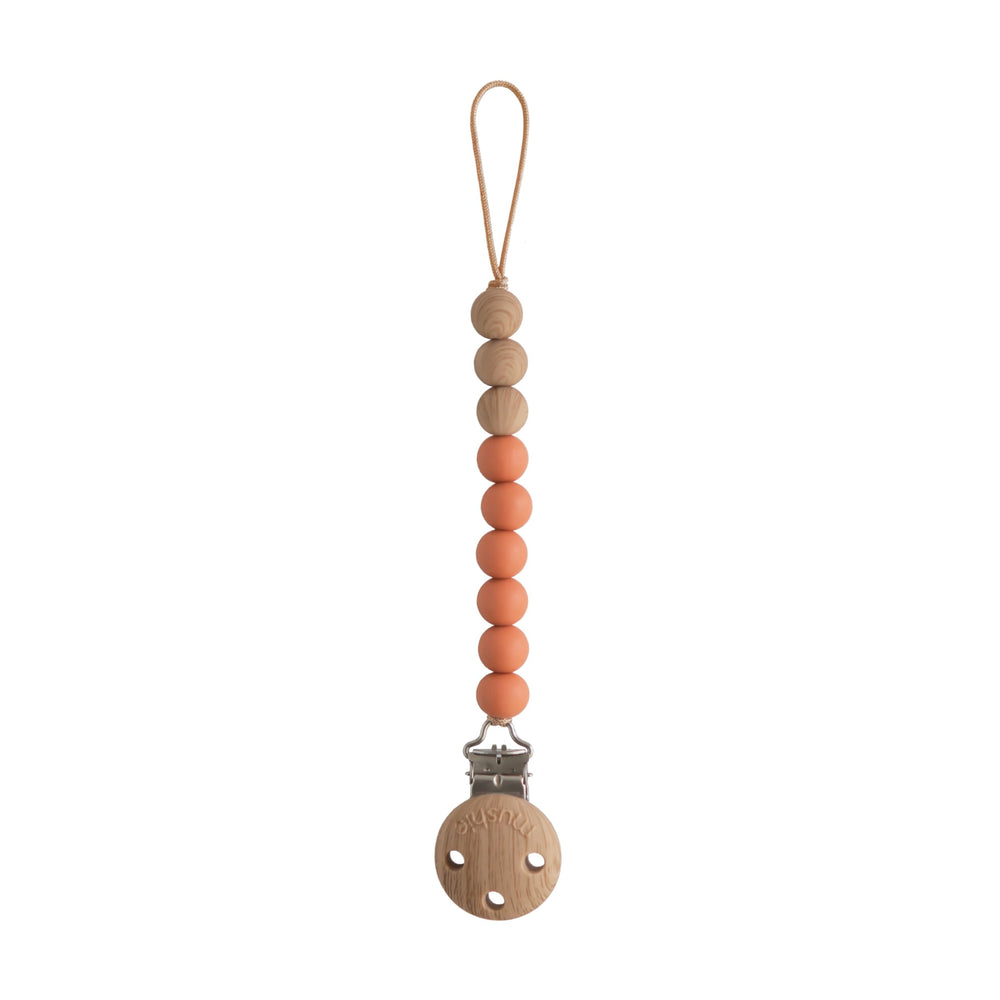 Mushie Eva clip beads closeup shows durable, BPA-free silicone for on-the-go soothing items.