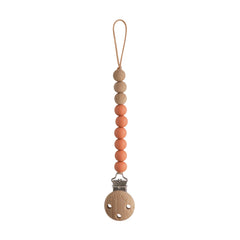 Mushie Eva clip beads closeup shows durable, BPA-free silicone for on-the-go soothing items.