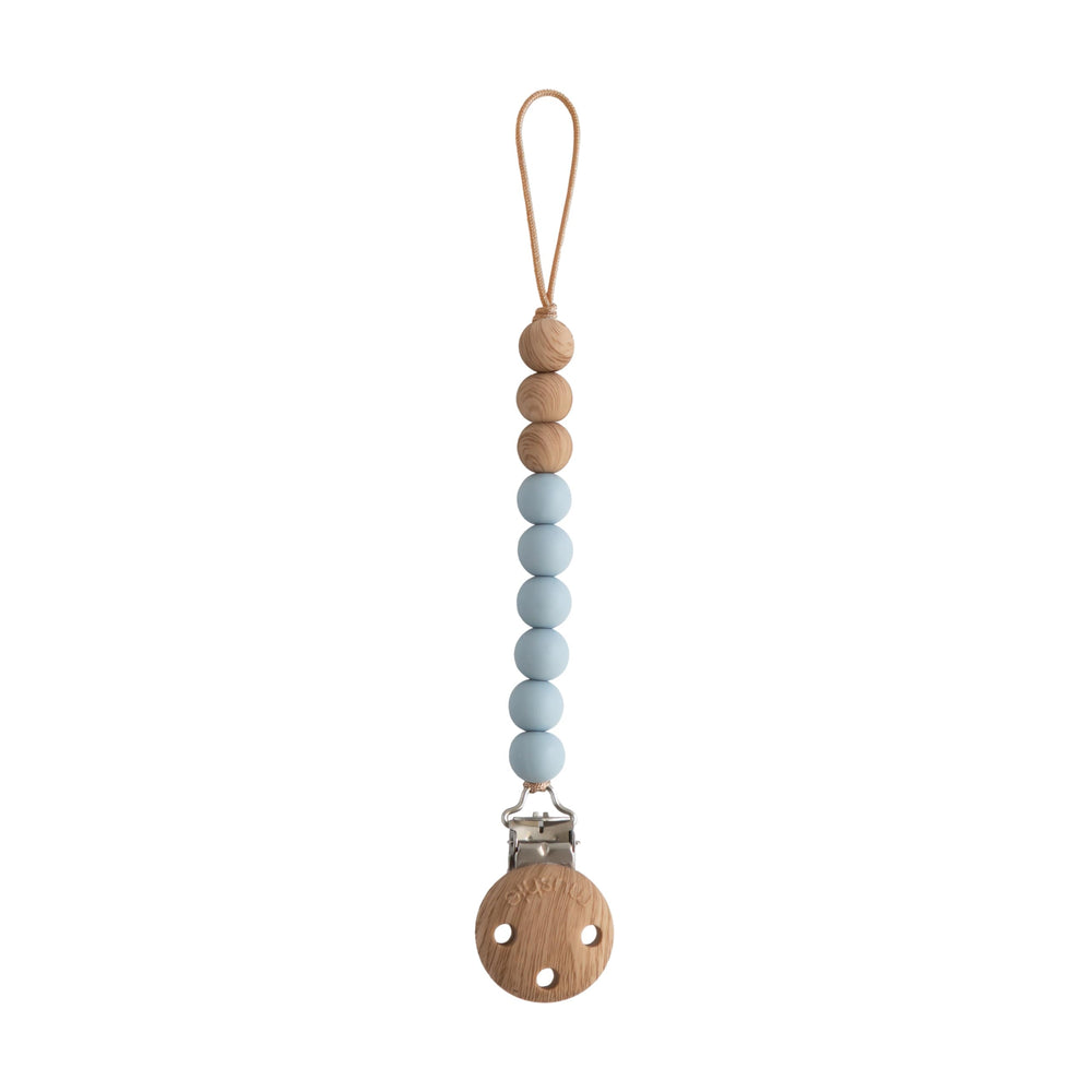 Mushie Eva silicone clip with a secure clasp for pacifier attachment.