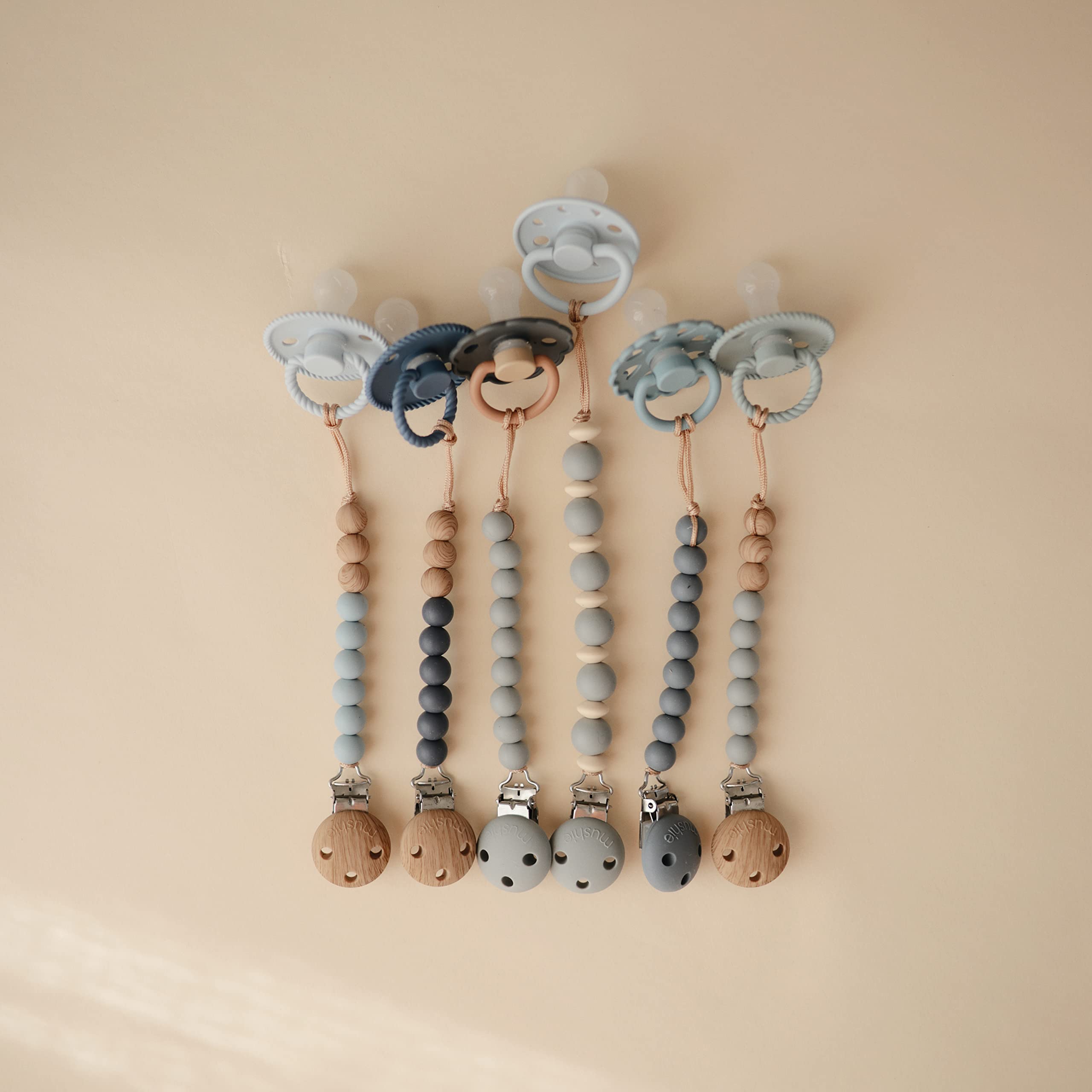 Mushie Eva two-tone beads offer a gentle grip on the pacifier.