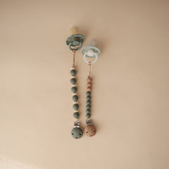 Mushie Eva molded silicone clasp keeps pacifier secure without screws