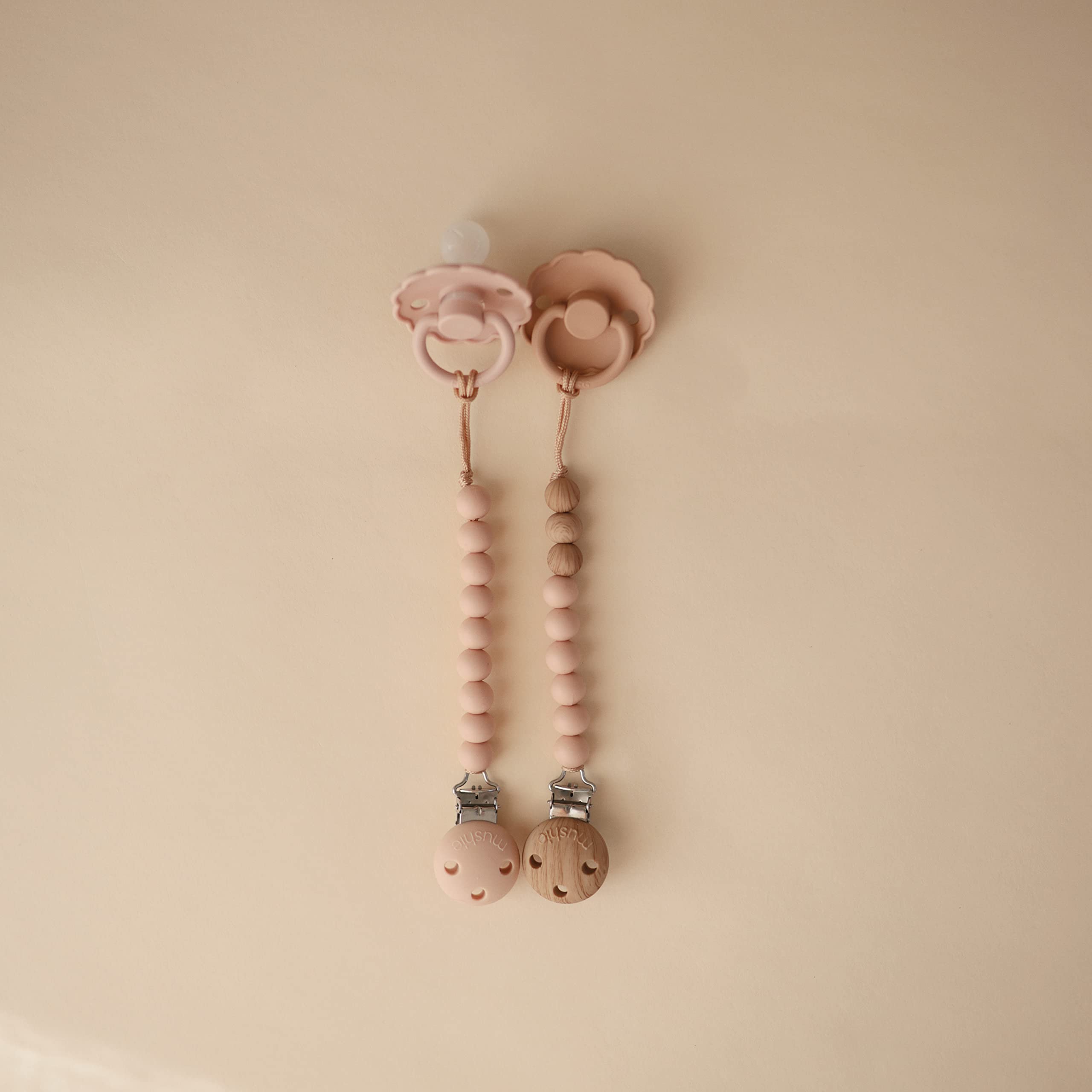 Mushie Eva pacifier clip molded clasp for easy attachment.