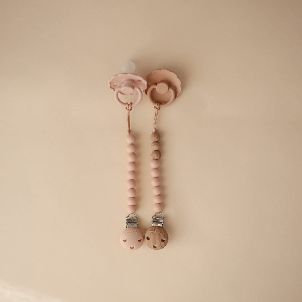 Mushie Eva pacifier clip molded clasp for easy attachment.