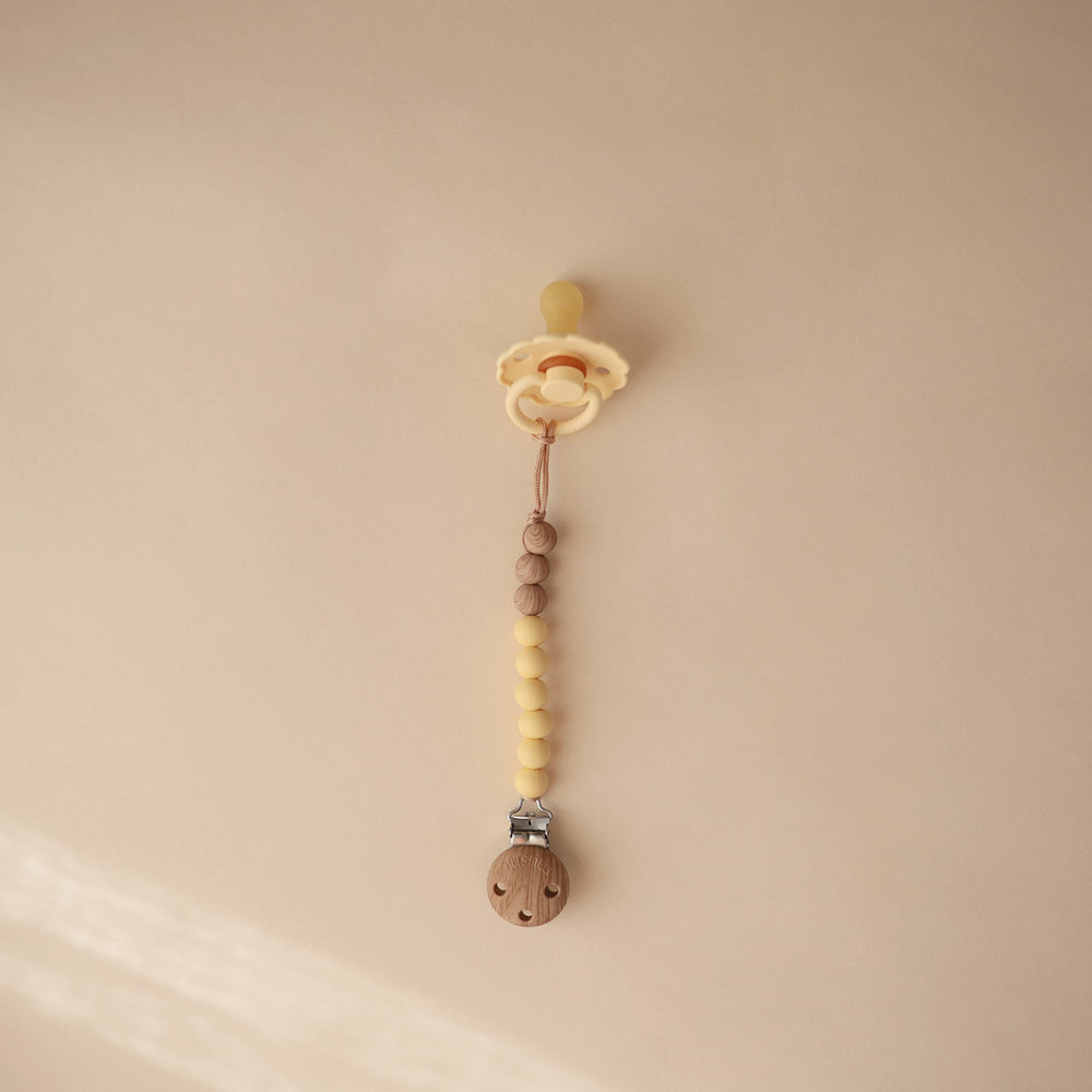 Mushie Eva two-color beads add style while keeping items within reach