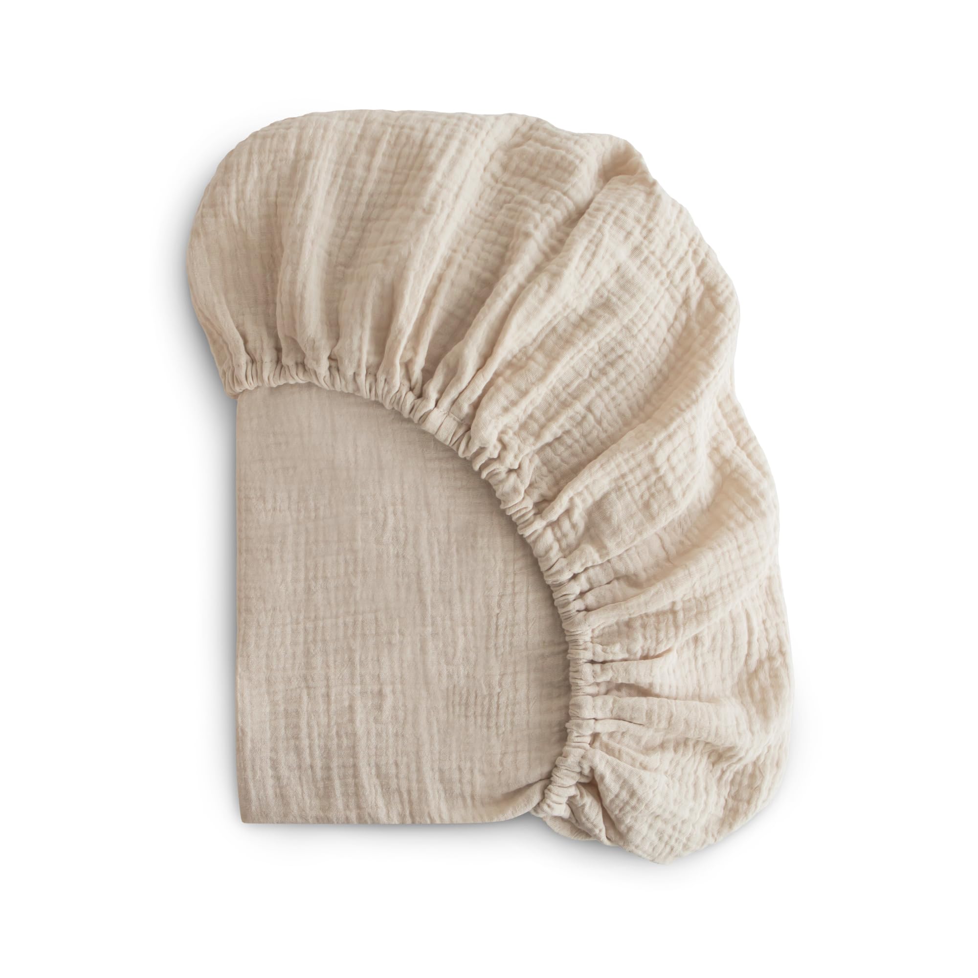 Mushie extra soft muslin fitted mini crib sheet Fog on mattress for breathable comfort.