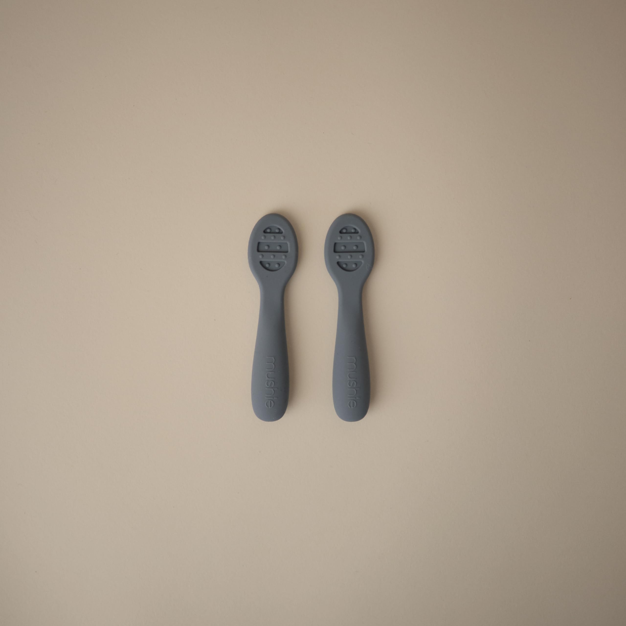 Mushie Stage 2 spoon showing open slots for thicker foods.
