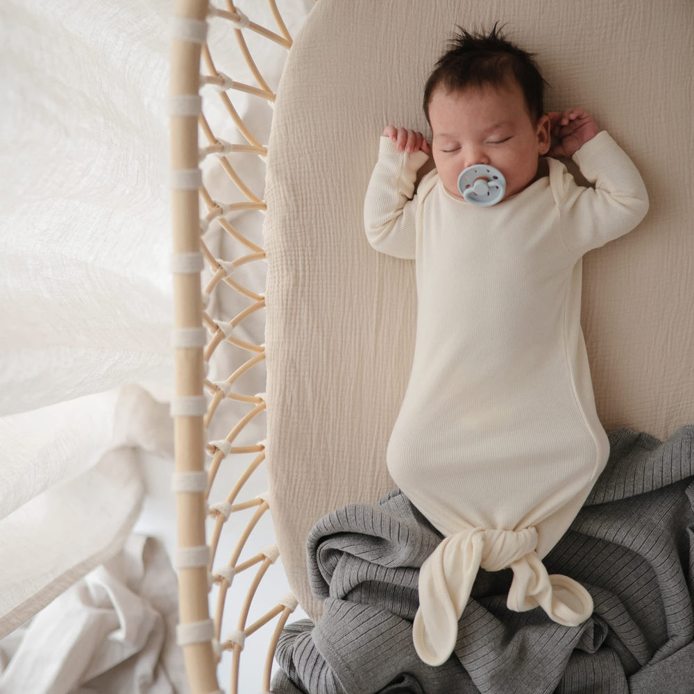 Mushie fitted mini crib sheet with full elastic edge for secure fit.