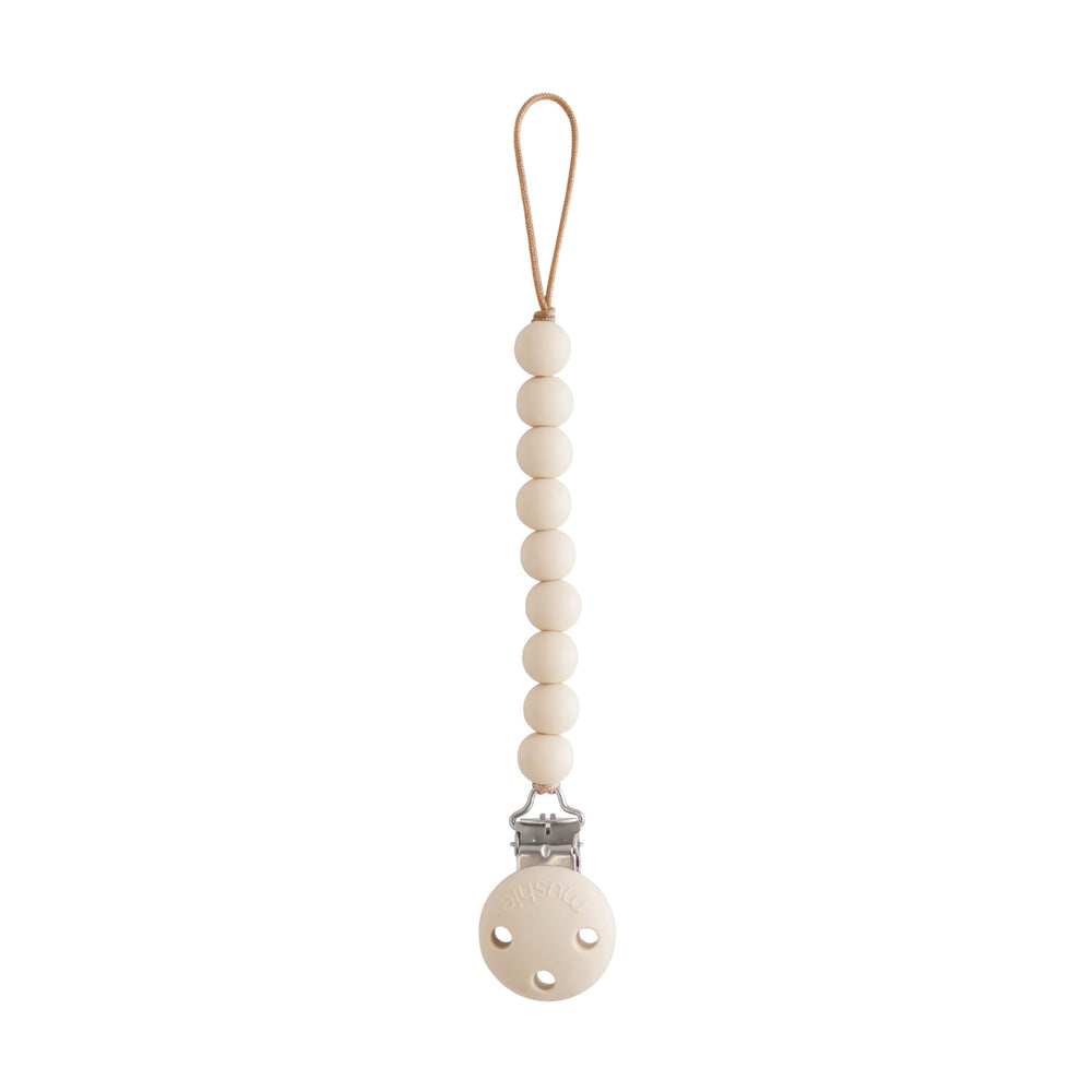 Mushie Hera pacifier clip with beaded stack keeps pacifier secure during outings.