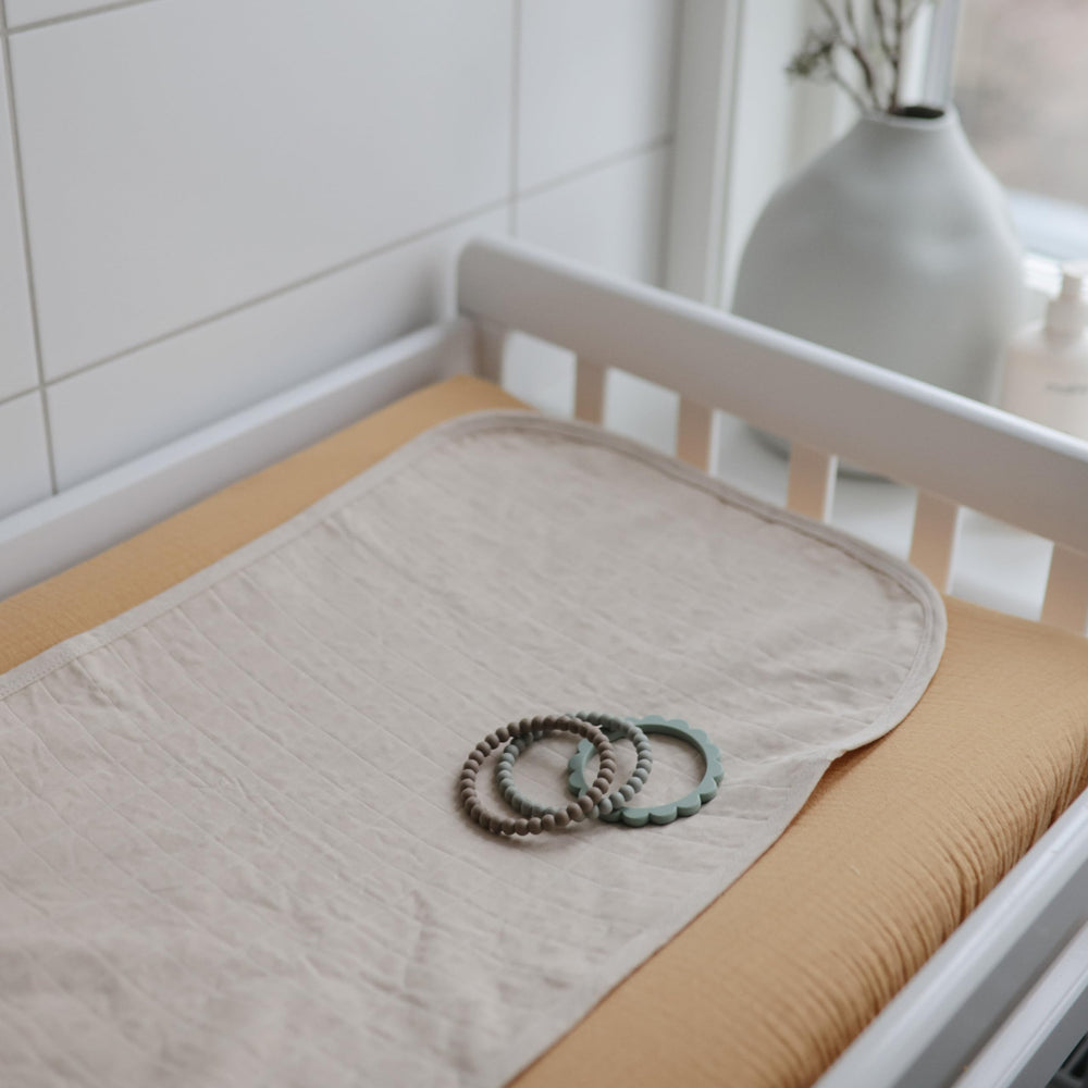 Mushie liner size 27.5x14 inches fits standard changing pads.