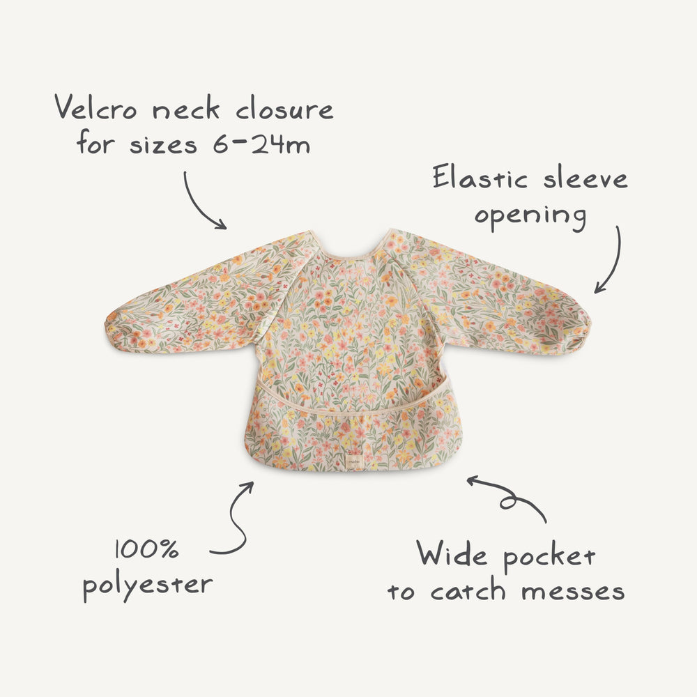 Mushie long sleeve bib worn on baby during mealtime