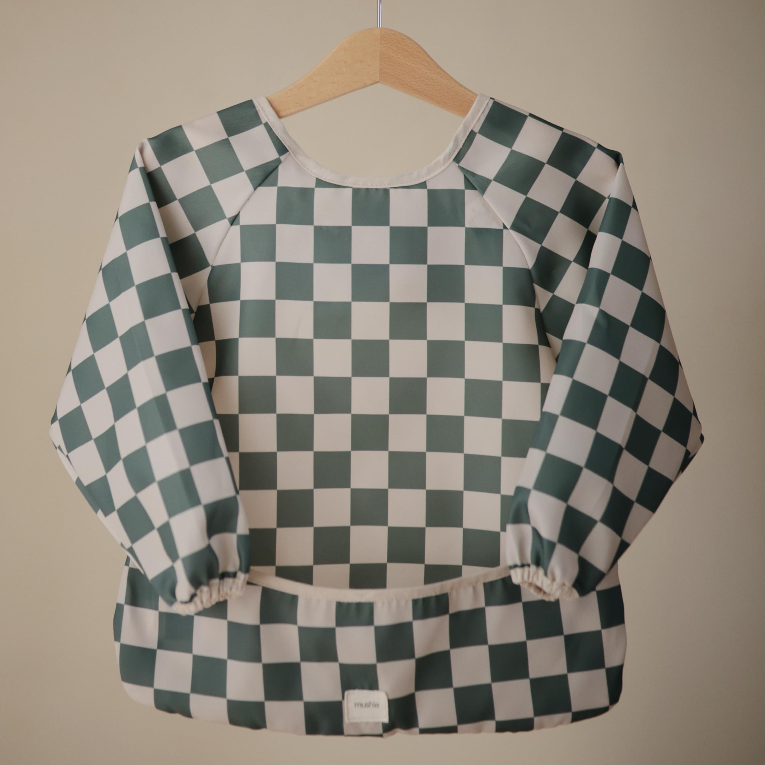 Mushie long sleeve bib Olive Check on a toddler during a meal