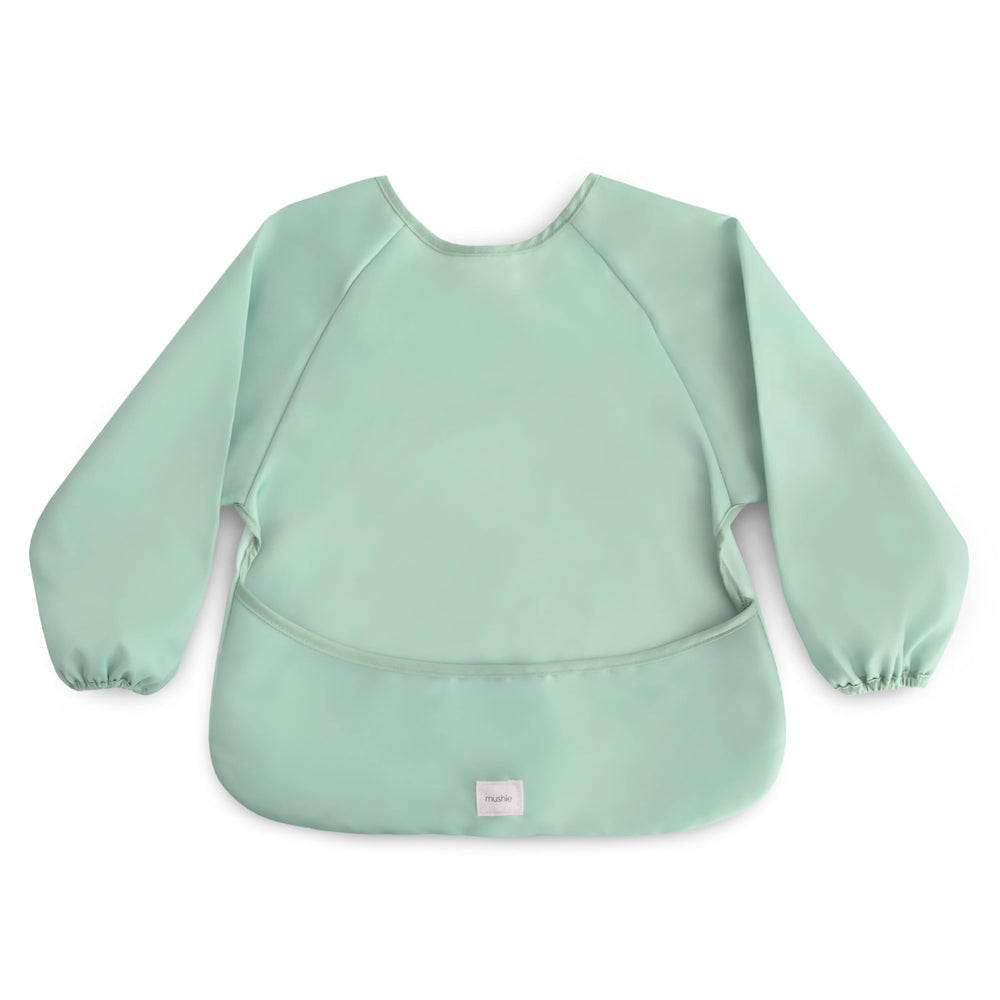 Mushie long sleeve bib in Roman Green with closeup stitching for durable meal protection