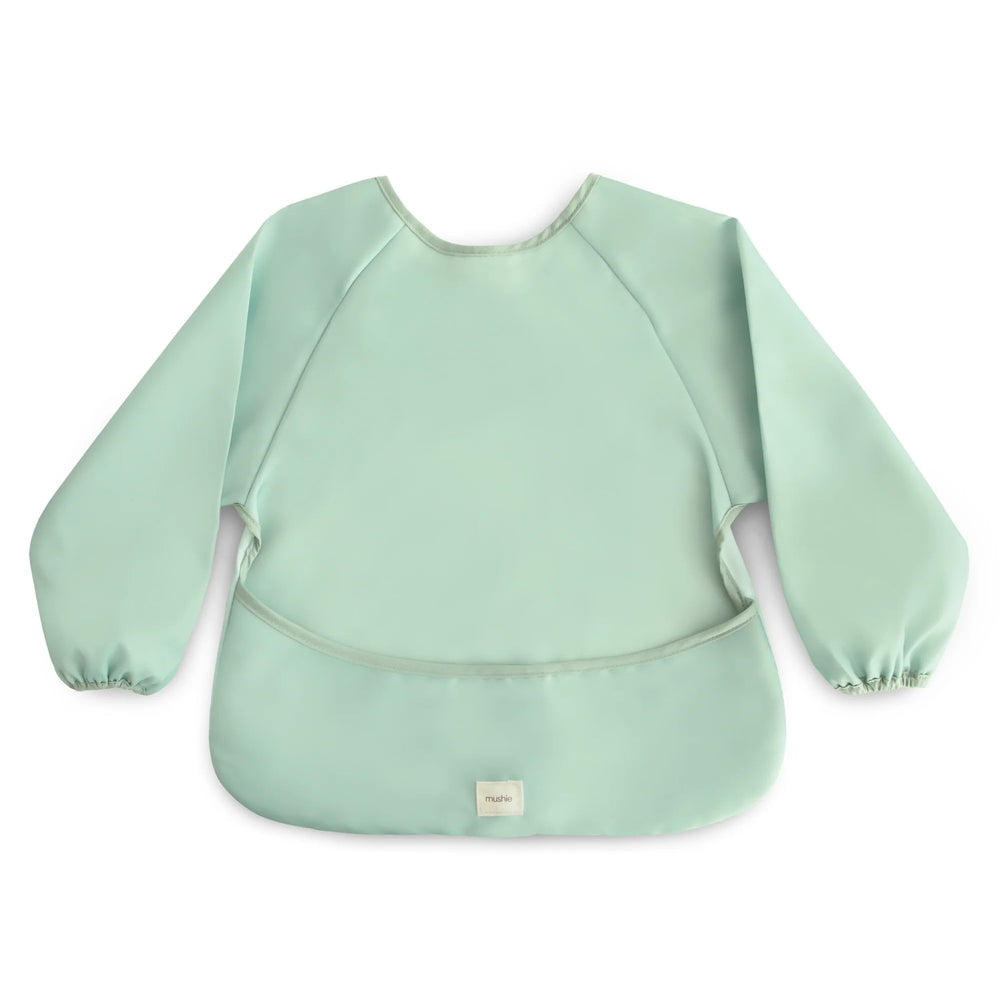 Mushie long sleeve bib in Roman Green features wipe-clean material for quick cleanup