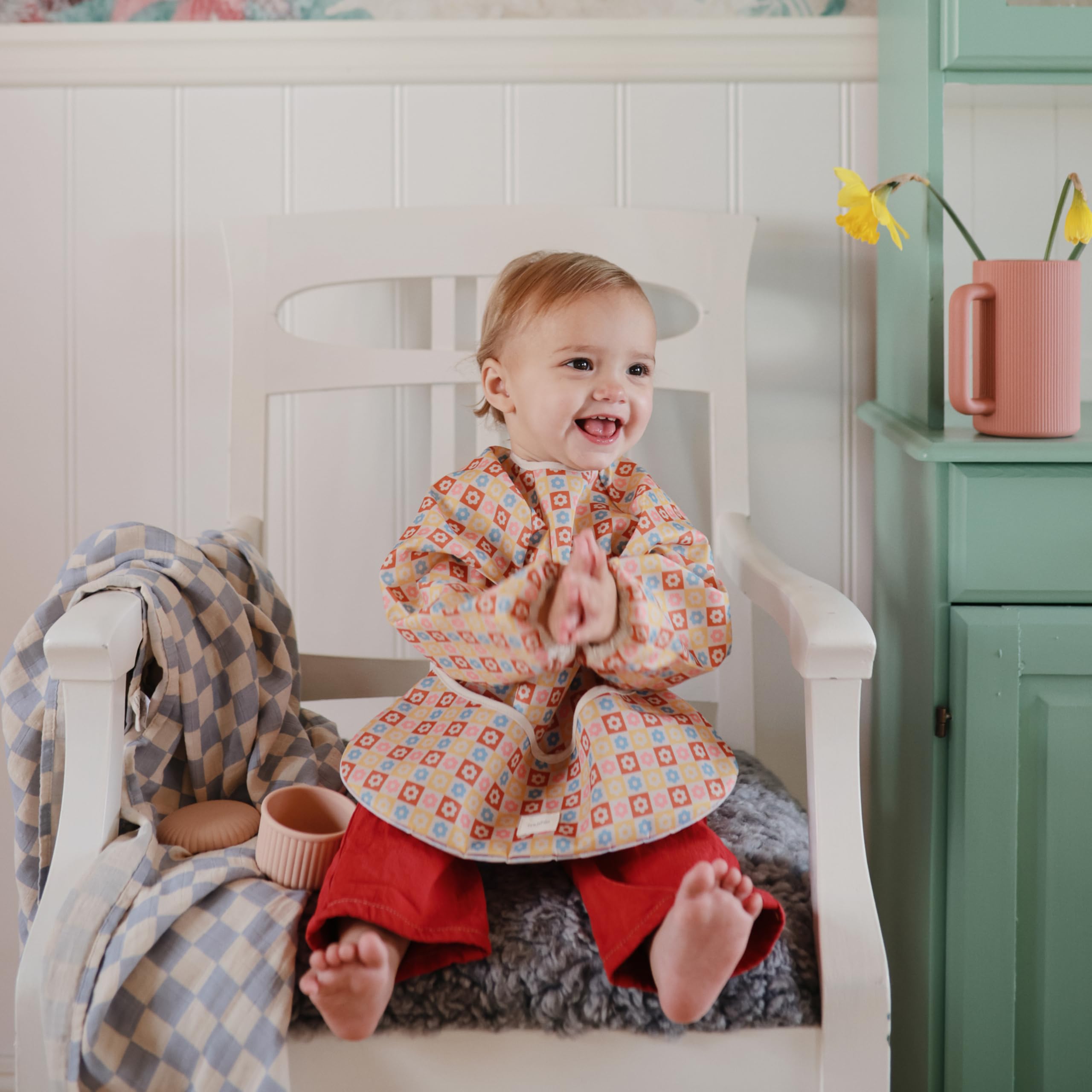 Mushie bib features soft cotton trim and durable polyester body