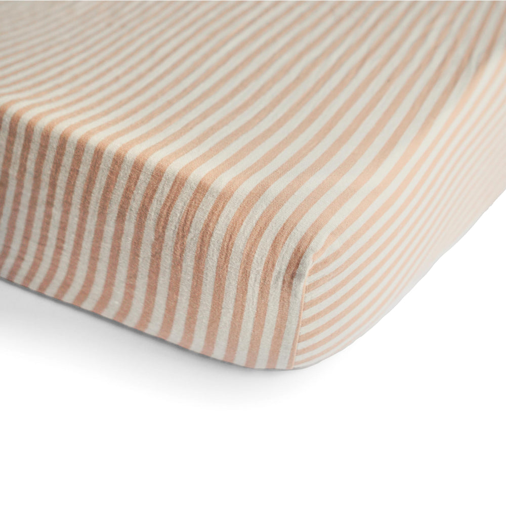 Mushie mini crib sheet on mattress with full elastic edge ensures a secure fit.