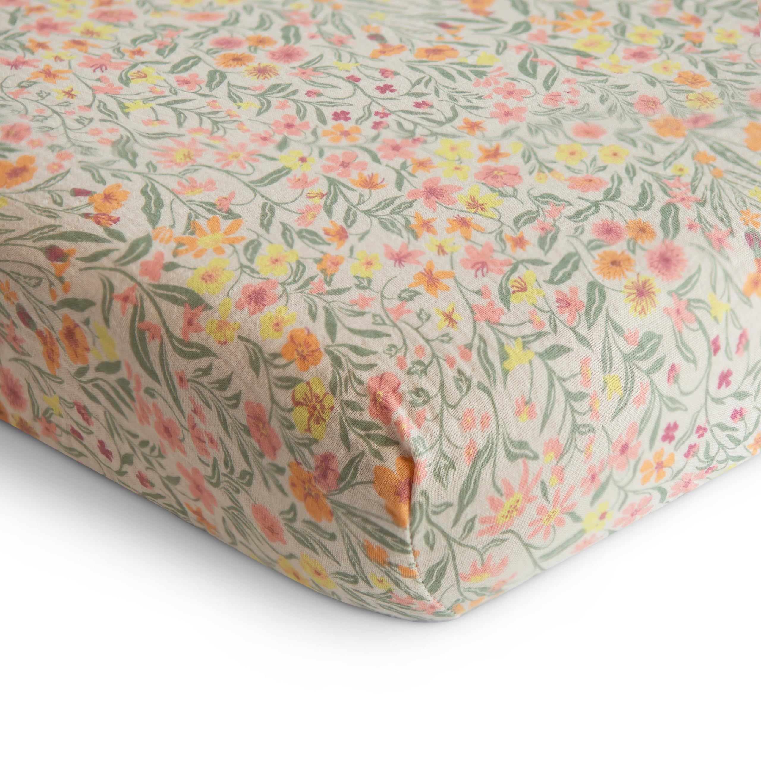 Mushie mini crib sheet on rectangle mattress showing snug fit for safe sleep.