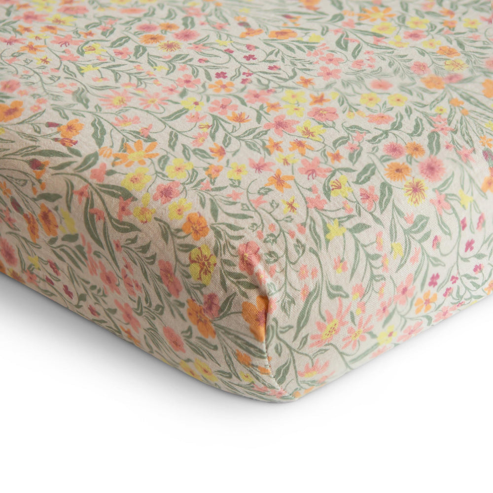 Mushie mini crib sheet on rectangle mattress showing snug fit for safe sleep.