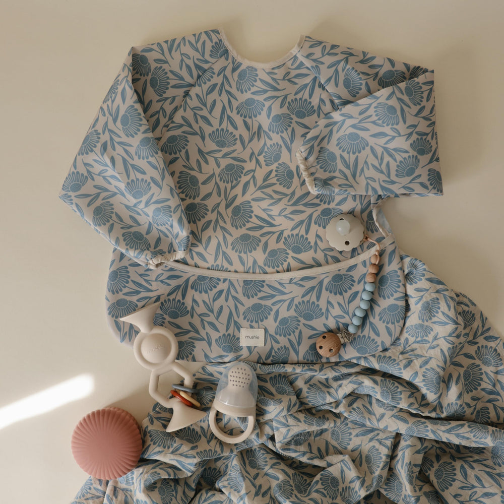 Mushie Muslin Swaddle Blanket blue flowers care guidelines to keep fabric soft.
