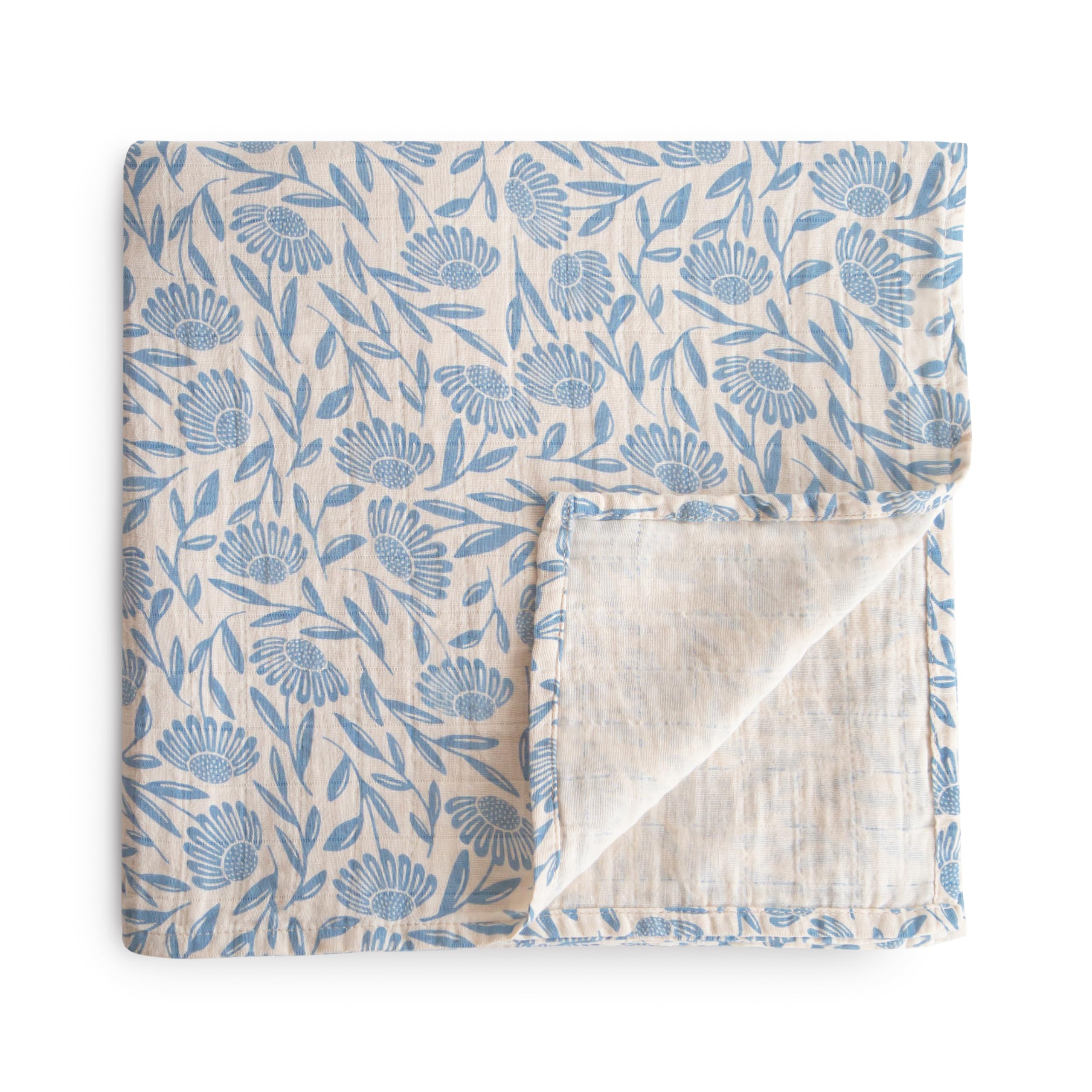 Mushie Muslin Swaddle Blanket blue flowers soft texture for newborn comfort.